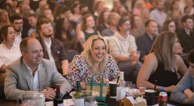 Man and woman sitting at table laughing Man and woman sitting at table laughing
